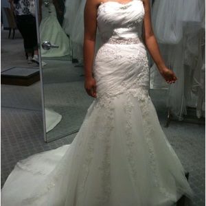Beautiful designer wedding dress. Never worn Formal bejeweled with full train.